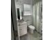 Bright bathroom with white vanity, toilet, and shower with patterned shower curtain at 126 W Morehouse Ave, Mooresville, NC 28117