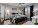 Bright bedroom with a king bed, wood floors, ceiling fan, and nightstands with lamps at 126 W Morehouse Ave, Mooresville, NC 28117