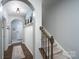 Inviting hallway featuring wood floors, white wainscoting, and staircase to the second floor at 126 W Morehouse Ave, Mooresville, NC 28117