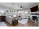 Cozy living room featuring a fireplace, a comfortable couch, and a ceiling fan at 126 W Morehouse Ave, Mooresville, NC 28117