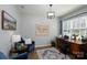 Cozy home office featuring a desk, a chair, artwork, and natural light from the window at 126 W Morehouse Ave, Mooresville, NC 28117