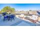 Relaxing outdoor patio with comfortable seating, dining table, and a view of the fenced backyard at 126 W Morehouse Ave, Mooresville, NC 28117