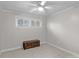 Cozy bedroom features a ceiling fan, window with blinds and a small wooden bench at 129 Hill Haven Rd, Statesville, NC 28677