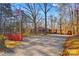 View of the front exterior of the brick home with long driveway and basketball court at 129 Hill Haven Rd, Statesville, NC 28677