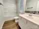 Well-lit bathroom featuring a tub-shower combo, single vanity, and modern fixtures at 1298 Bryson Ln, Denver, NC 28037