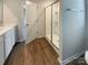 Bathroom featuring modern shower with glass door and white cabinets at 1298 Bryson Ln, Denver, NC 28037