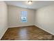 Cozy bedroom with light-filled window and modern flooring at 1298 Bryson Ln, Denver, NC 28037