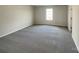 Spacious bedroom featuring gray carpet, ample natural light, and neutral wall colors at 1298 Bryson Ln, Denver, NC 28037