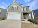Charming two-story home featuring a two-car garage, neutral siding, and well-maintained landscaping at 1298 Bryson Ln, Denver, NC 28037