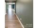 Hallway with modern hardwood floors and contemporary lighting at 1298 Bryson Ln, Denver, NC 28037