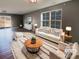 Inviting living room with large windows, modern furnishings, and stylish decor, virtually staged at 1298 Bryson Ln, Denver, NC 28037