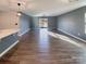 Open-concept living room with modern floors, a large window, and neutral wall colors at 1298 Bryson Ln, Denver, NC 28037