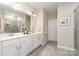 Bathroom with double vanity, tile floors, and a glass-enclosed shower at 14707 Batteliere Dr, Charlotte, NC 28278