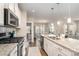 Gourmet kitchen with stainless steel appliances, a center island, granite countertops, and ample cabinet space at 14707 Batteliere Dr, Charlotte, NC 28278
