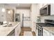 Modern kitchen featuring stainless steel appliances, granite countertops, and white cabinets at 14707 Batteliere Dr, Charlotte, NC 28278