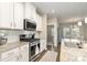 Contemporary kitchen with stainless steel appliances, white cabinets, granite countertops, and an open layout at 14707 Batteliere Dr, Charlotte, NC 28278