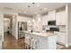Modern kitchen featuring stainless steel appliances, granite countertops, an island with seating, and white cabinets at 14707 Batteliere Dr, Charlotte, NC 28278