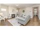 Cozy living room with hardwood floors, fireplace, natural light, and tasteful decor to provide a comforting atmosphere at 14707 Batteliere Dr, Charlotte, NC 28278