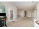 Large living room with neutral walls and carpet, featuring access to a rear patio at 14707 Batteliere Dr, Charlotte, NC 28278