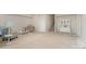Spacious living room with neutral walls and carpet, and a staircase to the upper level at 14707 Batteliere Dr, Charlotte, NC 28278