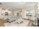 Open-concept living space with hardwood floors, a cozy fireplace, and seamless flow into the kitchen and dining areas at 14707 Batteliere Dr, Charlotte, NC 28278