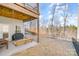 View of the backyard, showing the open patio with bench swing and a grill at 14707 Batteliere Dr, Charlotte, NC 28278