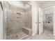 Walk-in shower featuring tile walls and a built-in seat in a Primary bath at 14707 Batteliere Dr, Charlotte, NC 28278