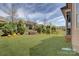 Spacious backyard featuring lush landscaping, mature trees, and an open lawn area at 14830 Creeks Edge Dr, Charlotte, NC 28278
