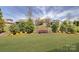 Beautifully landscaped backyard with mature trees and plenty of space for outdoor activities at 14830 Creeks Edge Dr, Charlotte, NC 28278