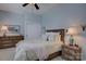 Bedroom with a wooden bed frame, ceiling fan, and a decorative dresser at 14830 Creeks Edge Dr, Charlotte, NC 28278