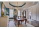 Elegant dining room with teal walls, a gold chandelier, and seating for six at 14830 Creeks Edge Dr, Charlotte, NC 28278