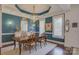 Elegant dining room with teal walls, a gold chandelier, and seating for six at 14830 Creeks Edge Dr, Charlotte, NC 28278