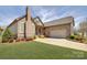 Charming stone home with manicured lawn and long driveway leading to attached two car garage at 14830 Creeks Edge Dr, Charlotte, NC 28278