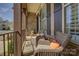 Cozy front porch with chairs, a table, and decorative shutters on the windows at 14830 Creeks Edge Dr, Charlotte, NC 28278