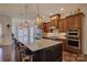 Gourmet kitchen with a large island, stainless steel appliances, and pendant lighting at 14830 Creeks Edge Dr, Charlotte, NC 28278