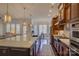 Bright and airy kitchen featuring a long island, hardwood floors, and shaker style cabinets at 14830 Creeks Edge Dr, Charlotte, NC 28278