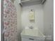 Laundry room with utility sink, ironing board and white walls at 14830 Creeks Edge Dr, Charlotte, NC 28278