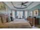 Spacious main bedroom featuring a tray ceiling, sitting area and a large bed at 14830 Creeks Edge Dr, Charlotte, NC 28278