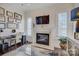 Bright office space with a fireplace, built-in shelving, and plenty of natural light at 14830 Creeks Edge Dr, Charlotte, NC 28278