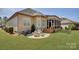 Cozy outdoor patio with grill, water fountain, and chairs for relaxing or entertaining at 14830 Creeks Edge Dr, Charlotte, NC 28278