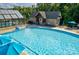 Community pool with umbrellas, lounge chairs, and changing cabana at 14830 Creeks Edge Dr, Charlotte, NC 28278