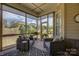 Inviting screened-in porch showcasing outdoor seating with a view of the well-maintained yard at 14830 Creeks Edge Dr, Charlotte, NC 28278