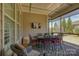 Comfortable screened-in porch with an outdoor dining area and ceiling fan for relaxation at 14830 Creeks Edge Dr, Charlotte, NC 28278