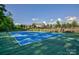 Community tennis court surrounded by trees in a landscaped setting at 14830 Creeks Edge Dr, Charlotte, NC 28278