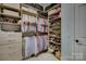 Custom walk-in closet with ample shelving, drawers, and storage for organization at 14830 Creeks Edge Dr, Charlotte, NC 28278