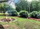 Backyard featuring a stone fire pit and colorful hydrangeas by the exterior of the home at 1496 Givens St, Hickory, NC 28602