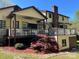 Expansive deck with seating and lush landscaping surrounding the home's exterior at 1496 Givens St, Hickory, NC 28602