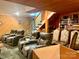 Finished basement area with multiple leather recliners, a bookshelf, and stairs leading to the upper level at 1496 Givens St, Hickory, NC 28602