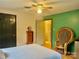 Bright bedroom with a ceiling fan, hardwood floors, and green accent wall providing a cool and inviting atmosphere at 1496 Givens St, Hickory, NC 28602