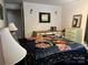 Well-lit bedroom with cozy floral bedding, a vanity desk, and soft, ambient lighting for a serene atmosphere at 1496 Givens St, Hickory, NC 28602